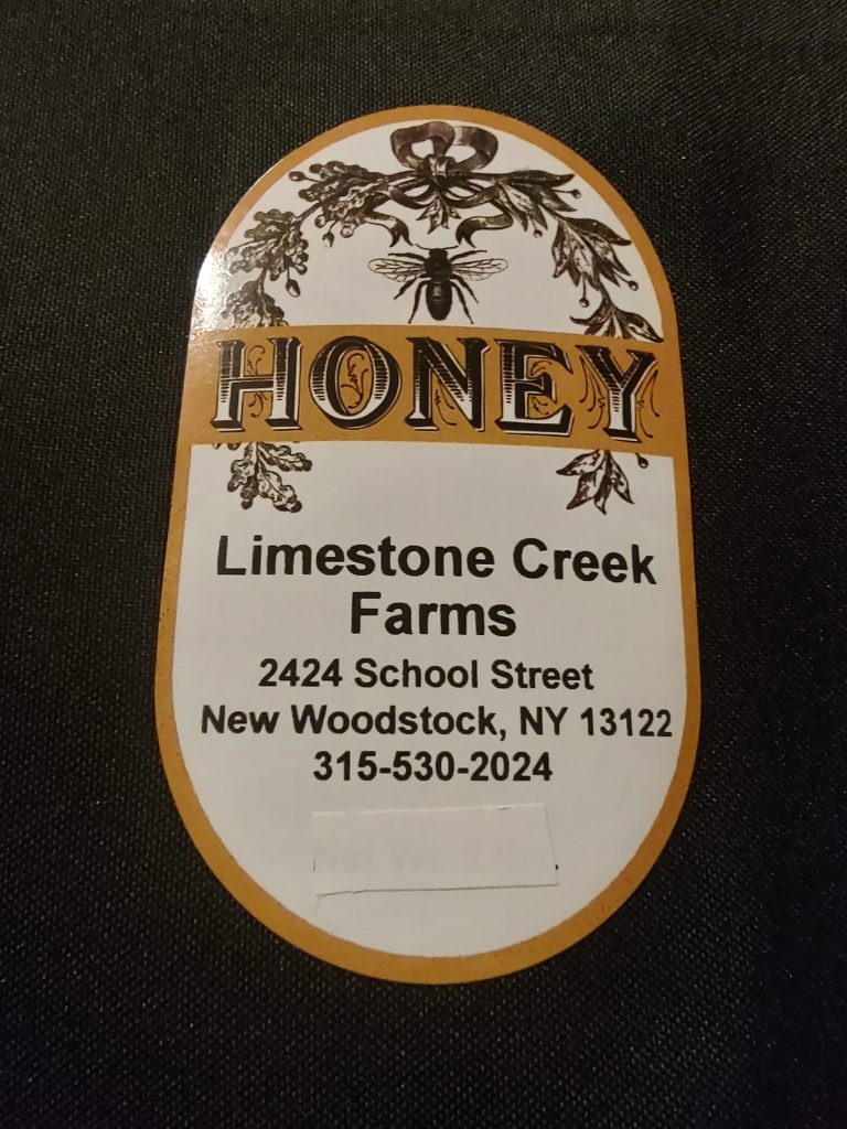 Sign that reads Honey Limestone Creek Farm and their address and phone number