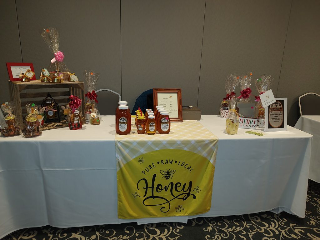 display table with honey products and honey sign