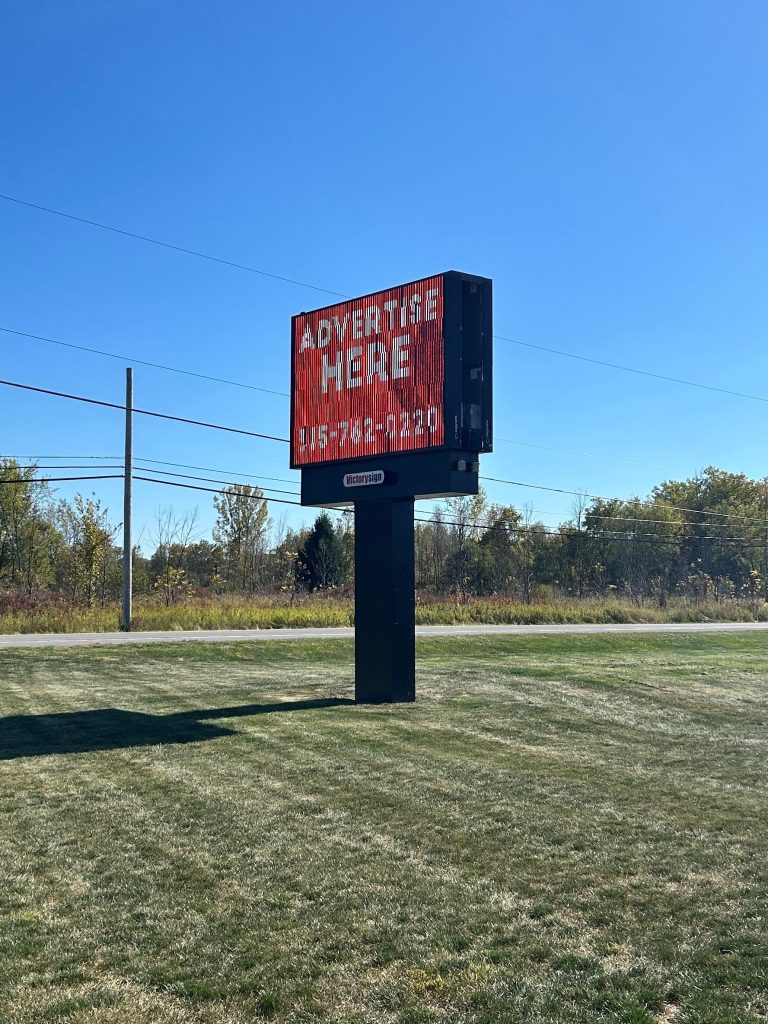 Large sign with red background with writing that says Advertise Here
